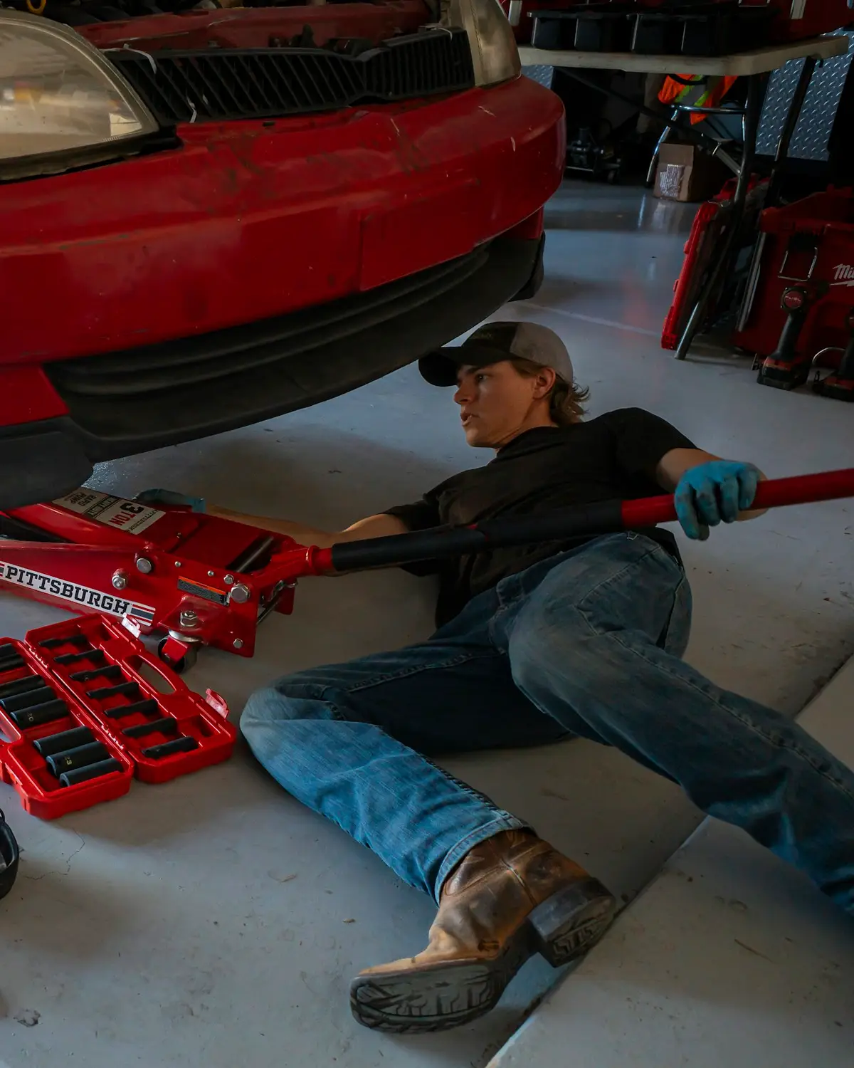 A car up on the ramp being worked on in the DREAM CARS workshop